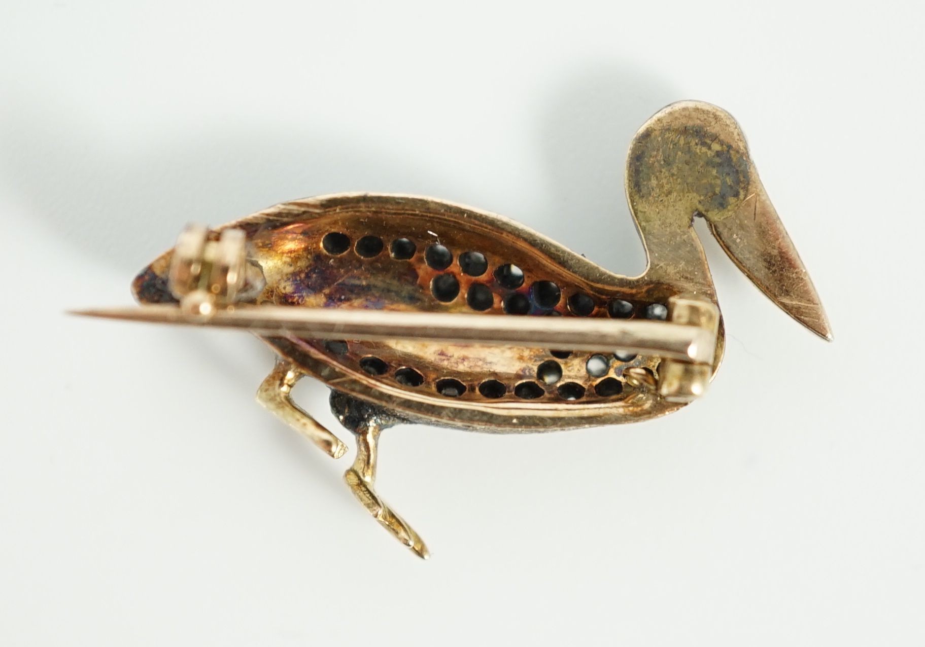 A Victorian style diamond encrusted and ruby set brooch, modelled as a pelican